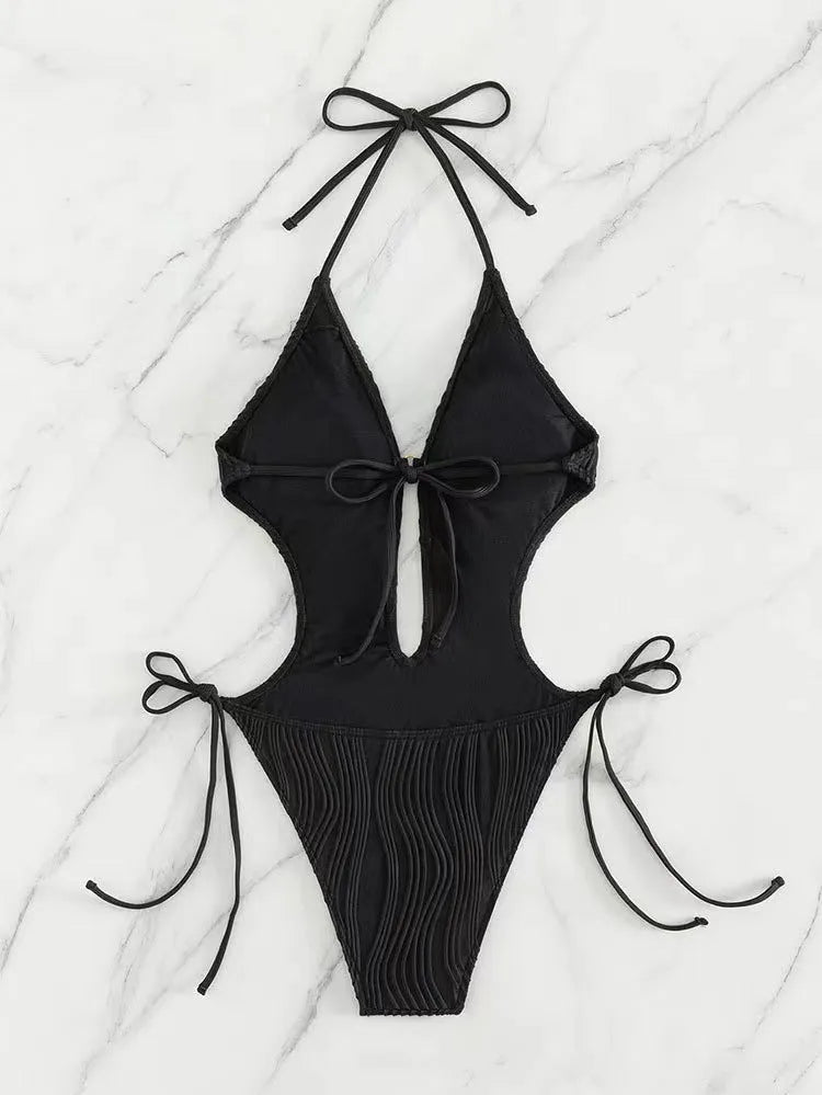 Women's black triangle bikini with lace-up detailing on white background