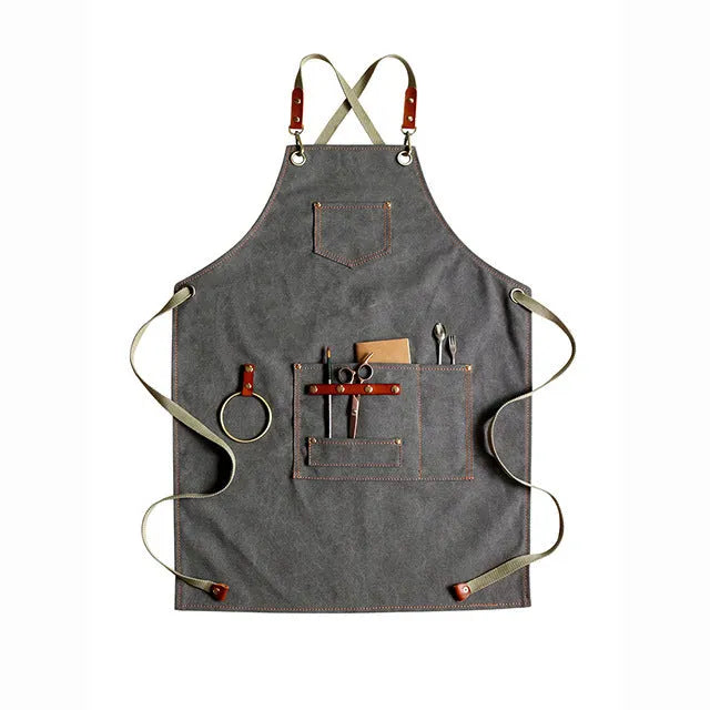 Canvas cross-strap apron in camel colour on hanger