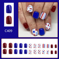 Short glossy false nails with strawberry cherry independence day pattern in red and blue colours