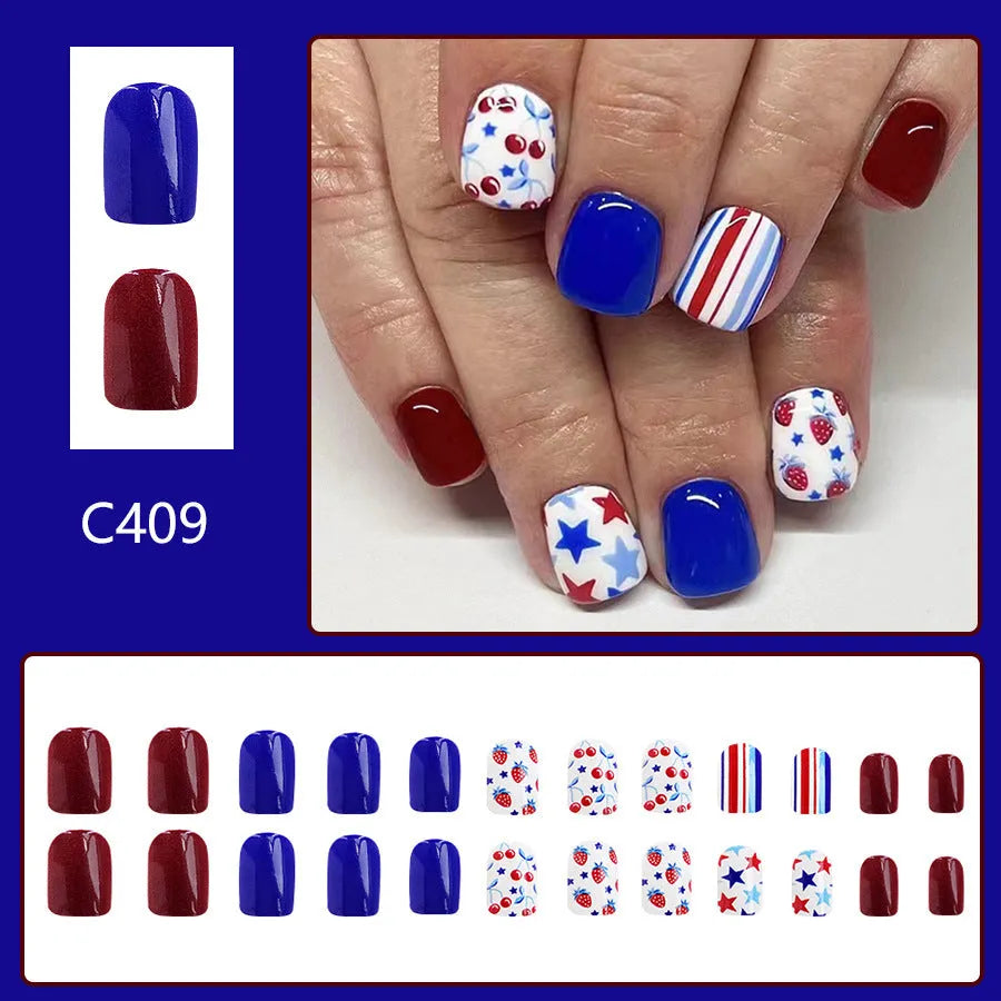 Short glossy false nails with strawberry cherry independence day pattern in red and blue colours