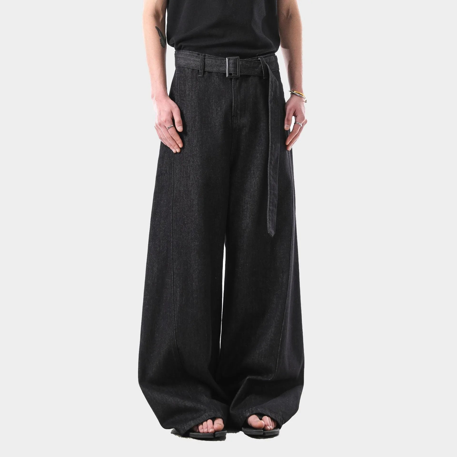 Black women's high waist straight leg jeans with gold detailing on a mannequin, showing the zip fly and classic denim cut.