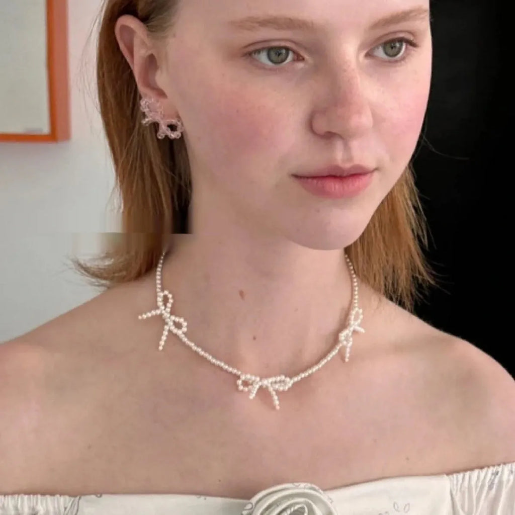 White imitation pearl necklace with bow pendant on adjustable 31-40cm chain