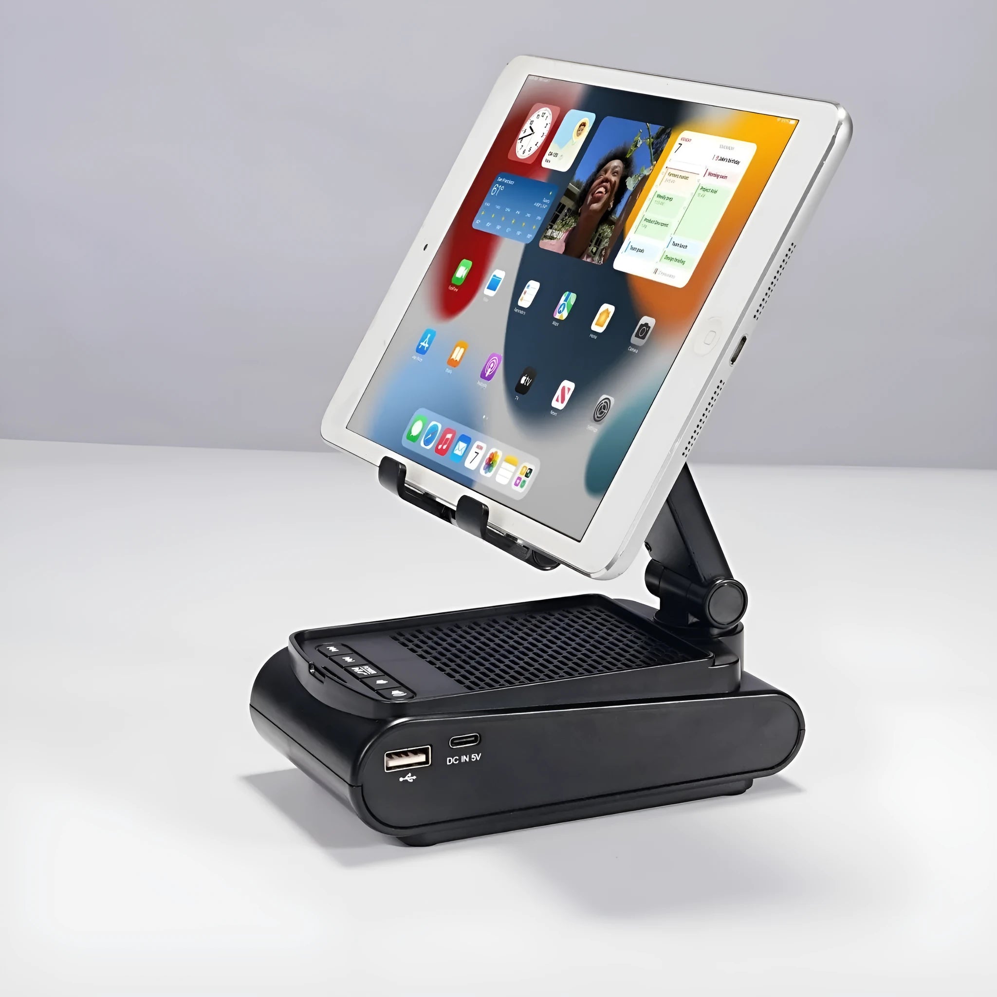 Multi-function lazy phone holder with Bluetooth audio in black plastic on a desk showing a smartphone in landscape mode