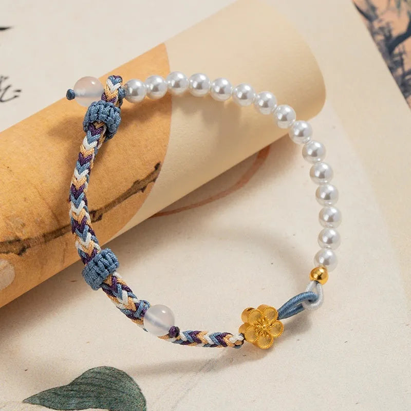 Peach-coloured cord bracelet with sterling silver Chinese flower weaving, chalcedony and pearl details.