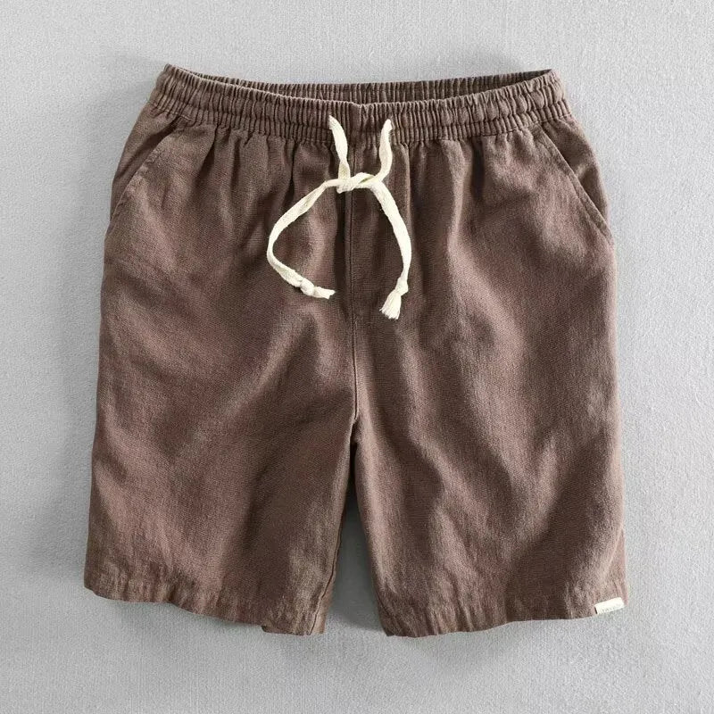 Man wearing loose-fitting cotton and linen casual shorts in a straight-leg style with an elasticated waist.