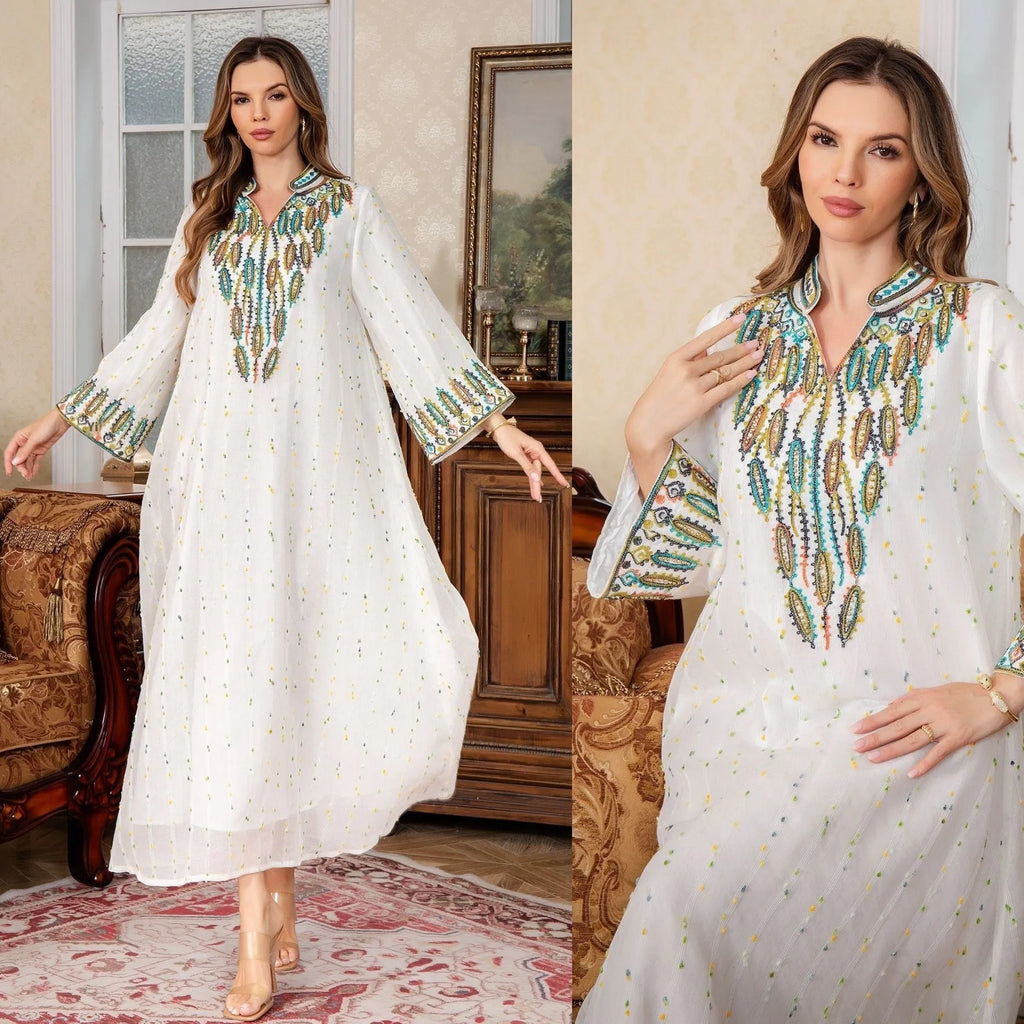White polyester Arabic robe with long sleeves and full-length skirt on hanger