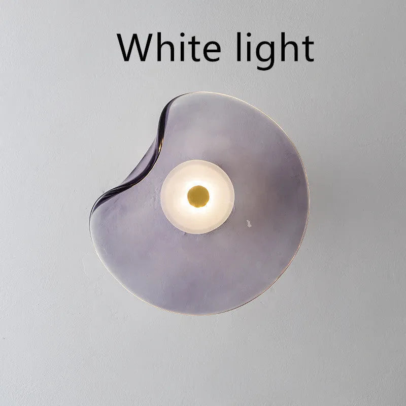 Round decorative wall lamp with glass shade in cognac colour for bedroom bedside lighting