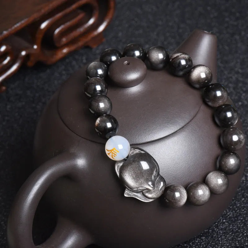 Natural black obsidian bracelet with 10mm beads and zodiac design in gold, silver, or pure stone variations