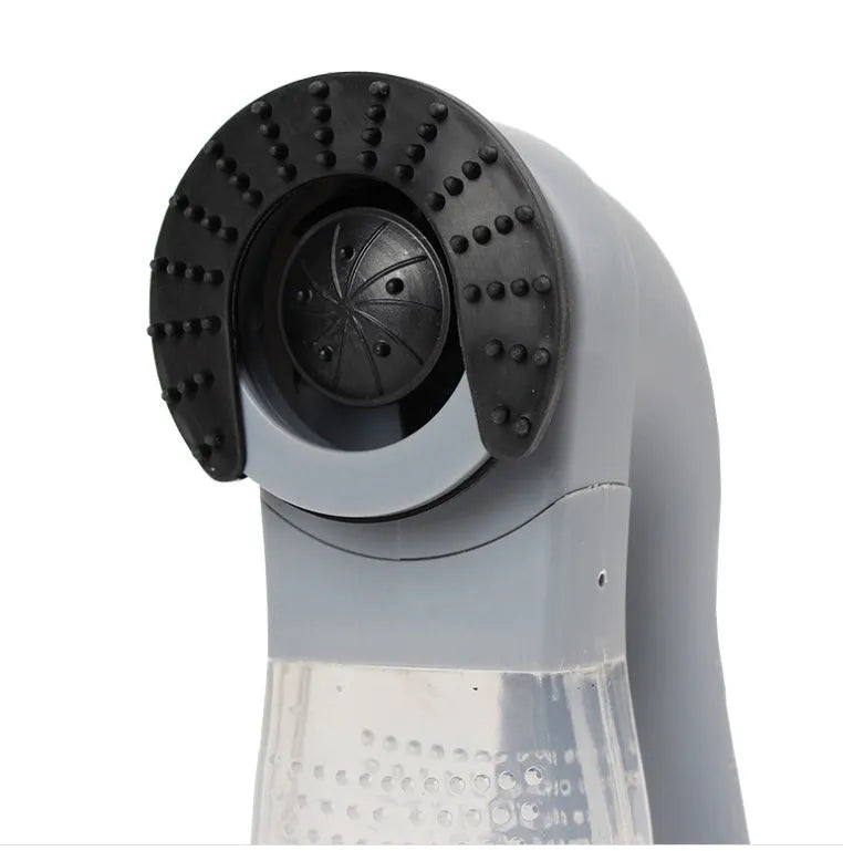 Grey portable pet hair vacuum cleaner with soft rubber grooming head on a fabric sofa