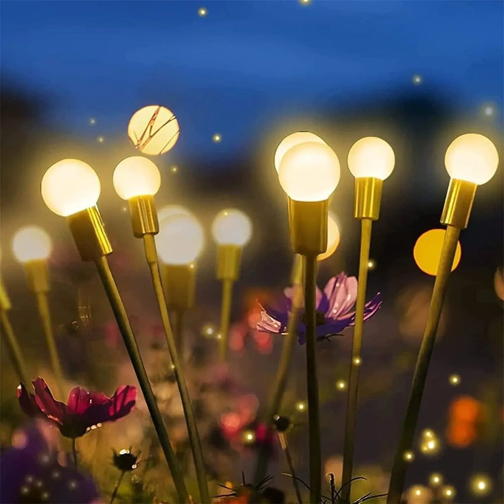 Solar-powered LED garden lamp with multiple light heads and ground plug stakes on a lawn