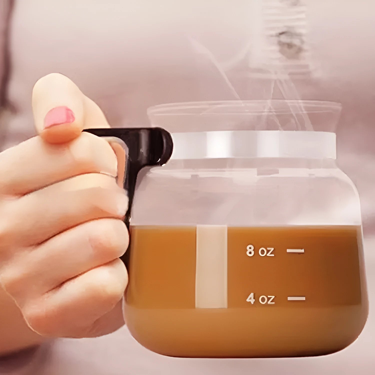 Transparent borosilicate glass coffee maker with silicone cover showing modern simple design