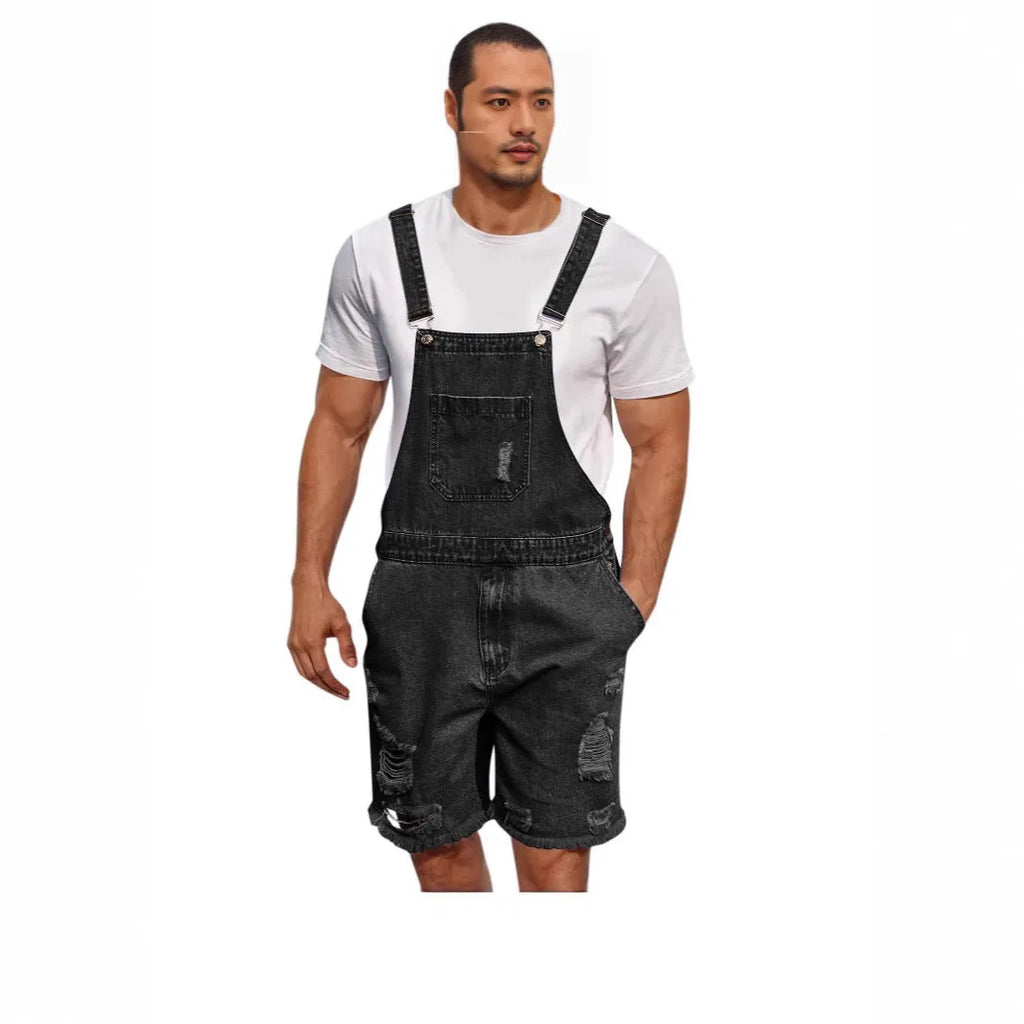 Man wearing dark blue ripped denim shorts with black suspenders, casual leisure style