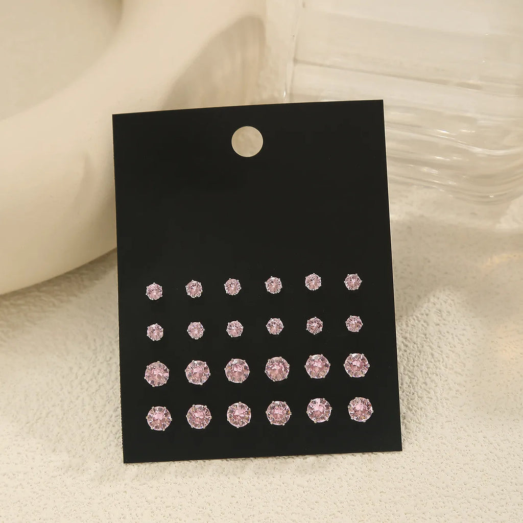 Pink round women's earrings set of 12 pairs on display, alloy with electroplated finish, geometric stud style