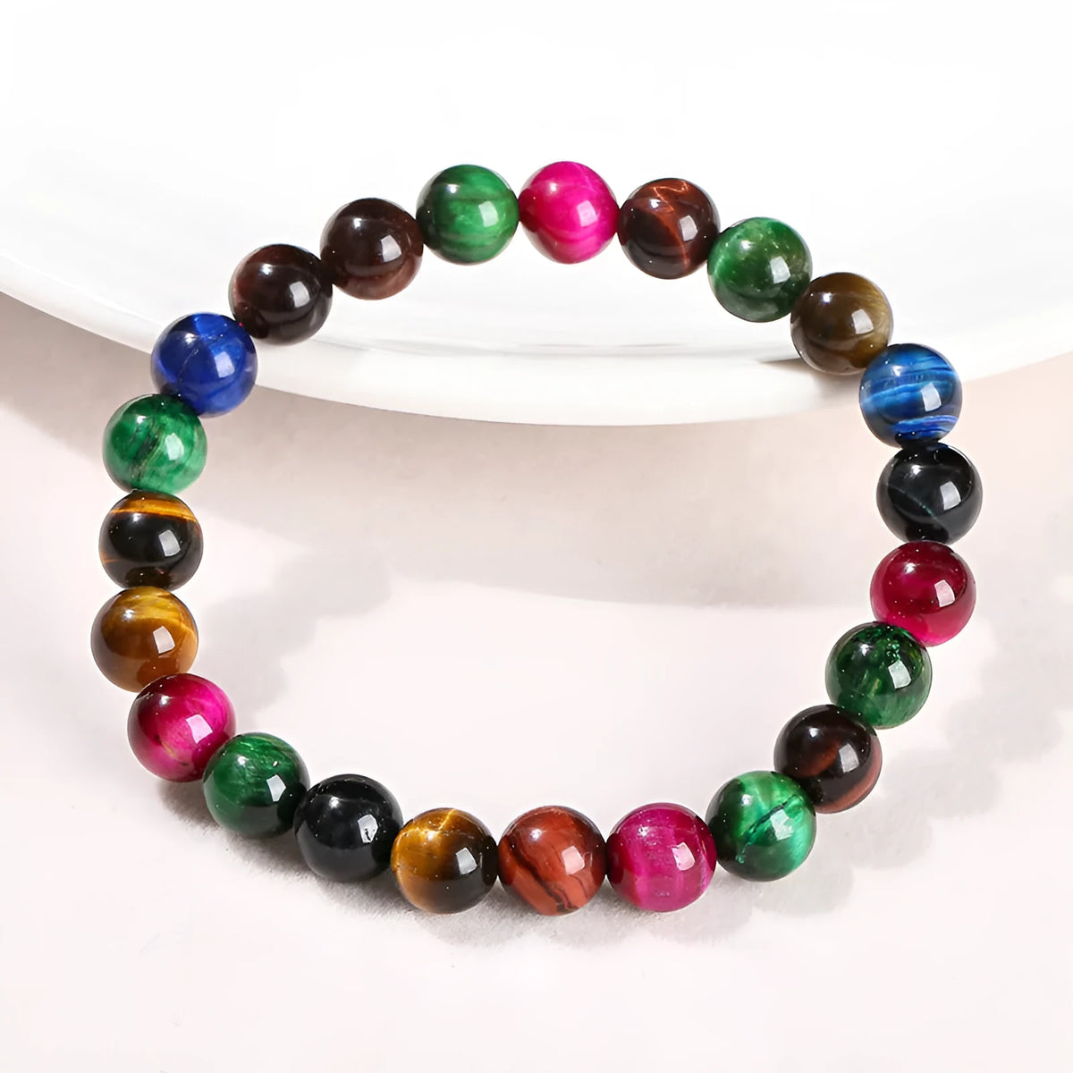 Colourful tiger-eye stone beaded bracelet with round beads on a cord, showing size options.