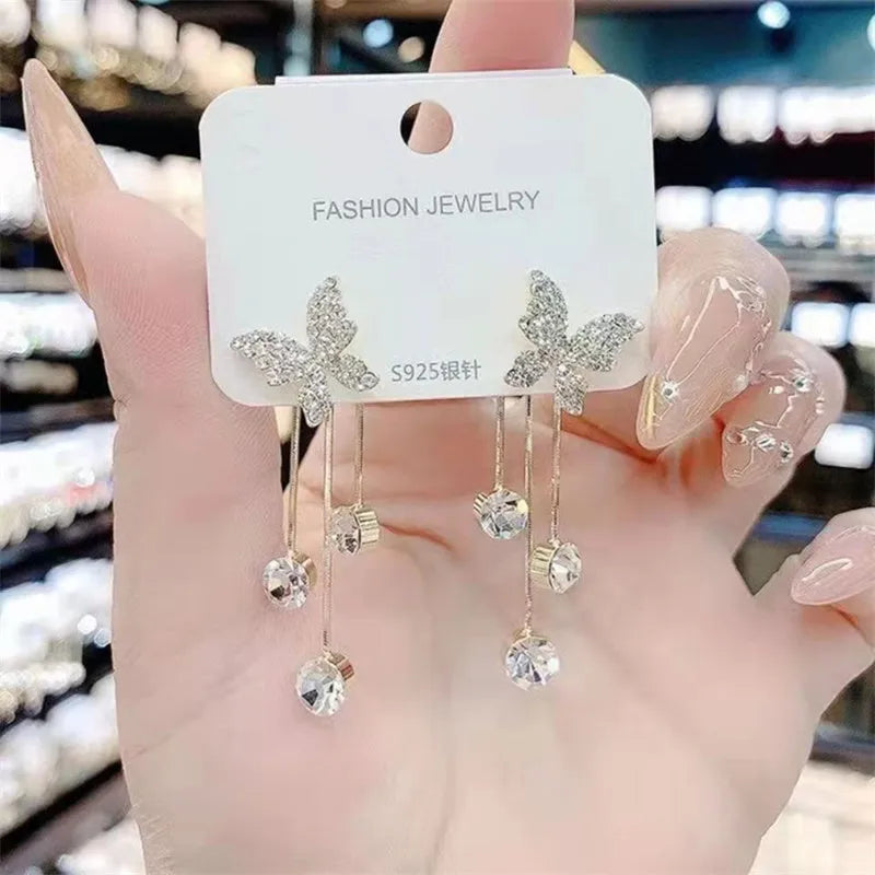 Silver butterfly rhinestone drop dangle earrings with pearl tassel chain and heart elements on alloy