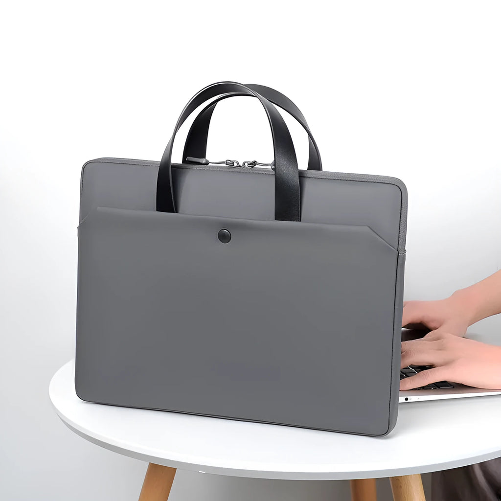 Ultra-thin leather laptop case in light gray with zipper closure and soft handle for 15.6-inch laptop