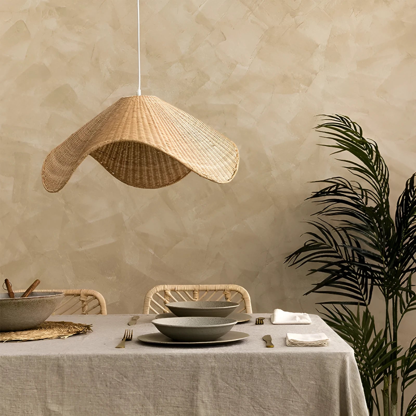 Handmade natural rattan and willow bamboo chandelier with warm LED light in a rustic setting.