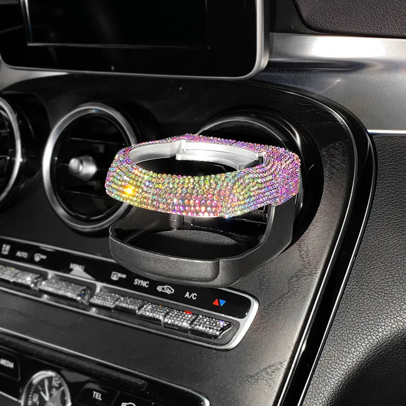 Car interior water cup bracket with decorative diamond accents mounted on air vent