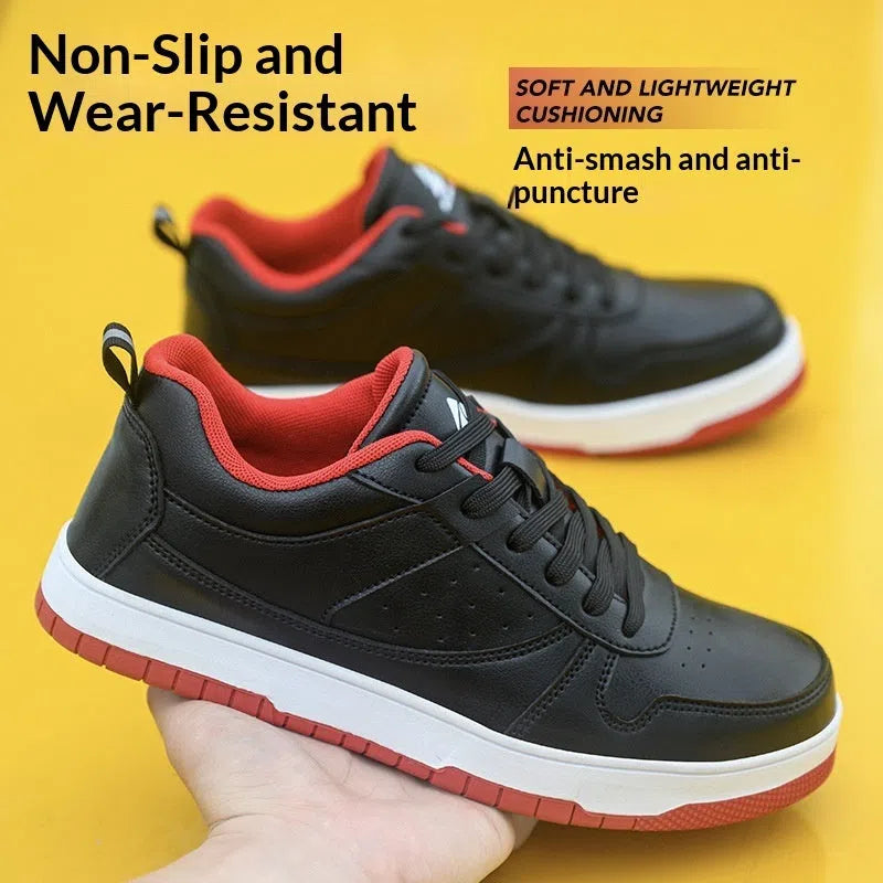 Black low-cut anti-smash anti-puncture safety work shoes with rubber sole on a workshop floor
