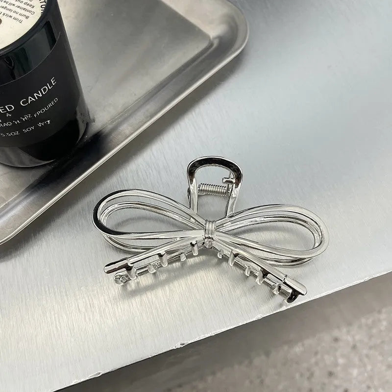 Women's Korean style bow hair barrette with alloy construction in silver or gold colour option