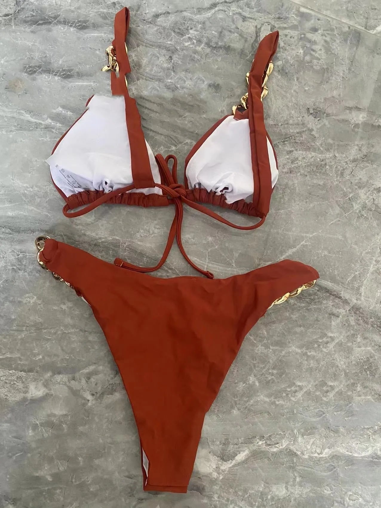 Brown tube-top push up bikini swimsuit with a ring tether detail on an adult female model.