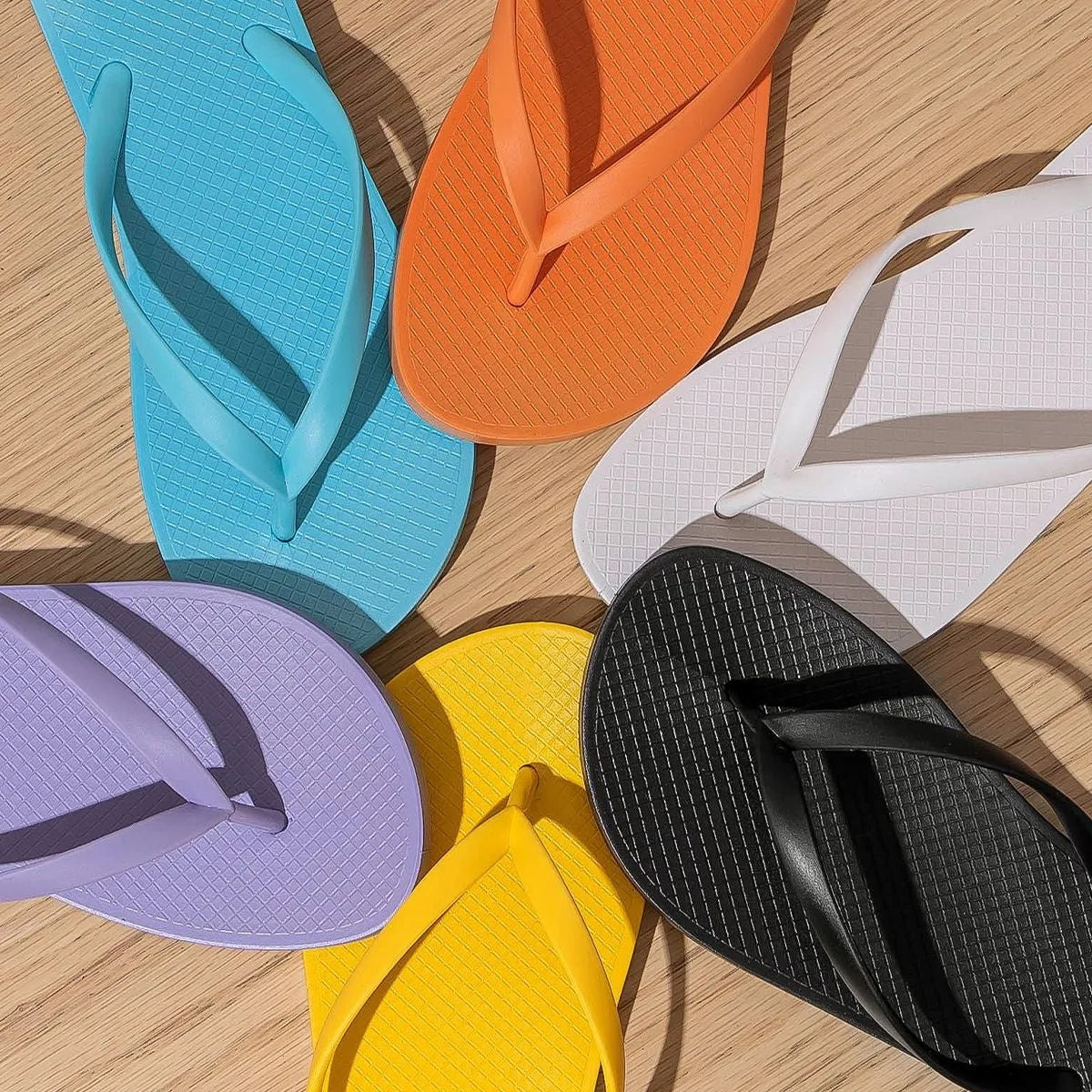 Foldable casual beach slippers in black with hollow out plastic upper and non-slip PVC sole.
