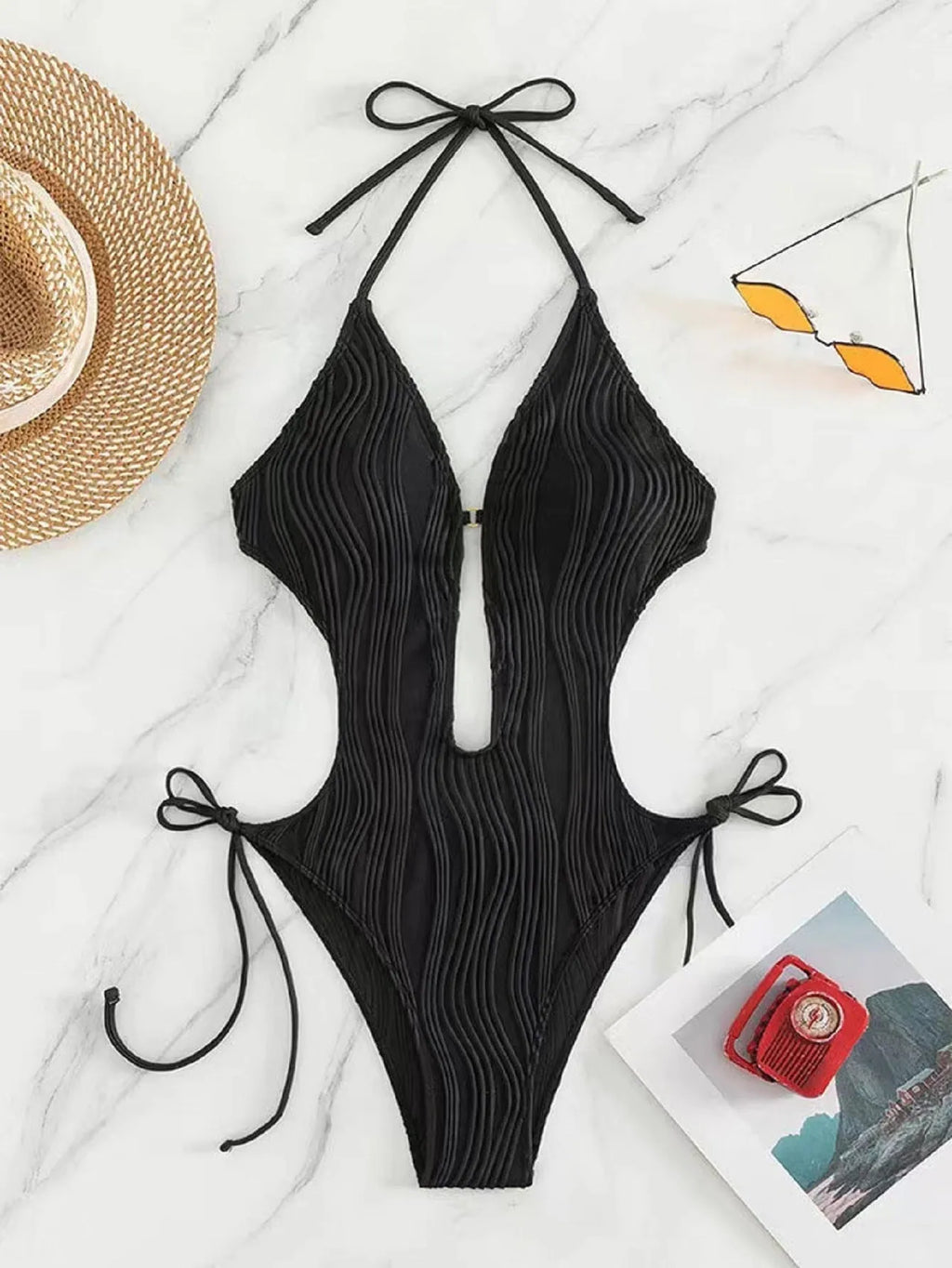 Women's black triangle bikini with lace-up detailing on white background