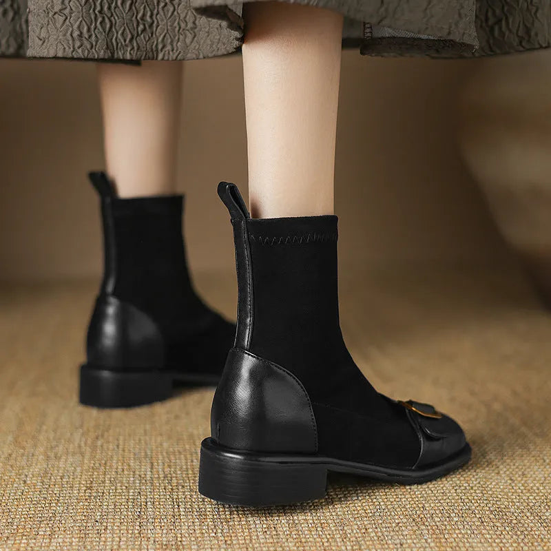 Women's black casual Martin ankle boots with belt buckle stitching and white laces on a rubber sole.