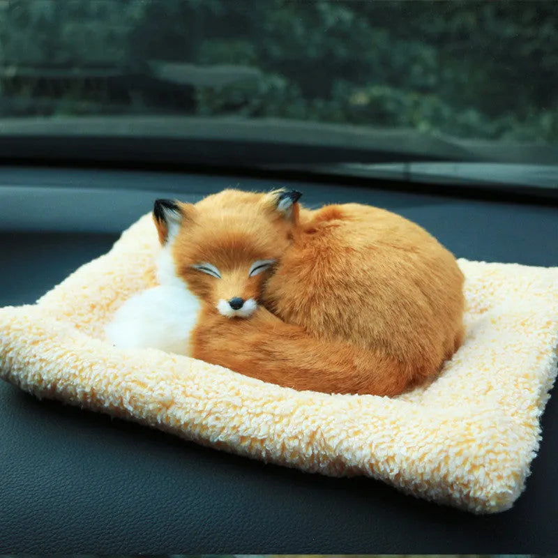 Fox bamboo charcoal car deodorant doll with white fur and red check pad on cloth surface