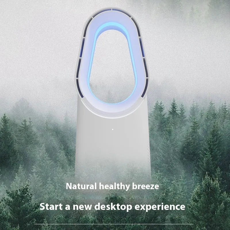 A white bladeless tower fan with a remote control on a wooden floor next to a desk.