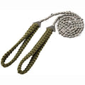 Army Green braided rope pocket saw fully extended to 103 cm length on outdoor ground surface
