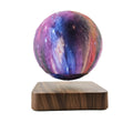 Magnetic levitation galaxy decorative light with floating moon lamp rotating above walnut-coloured base