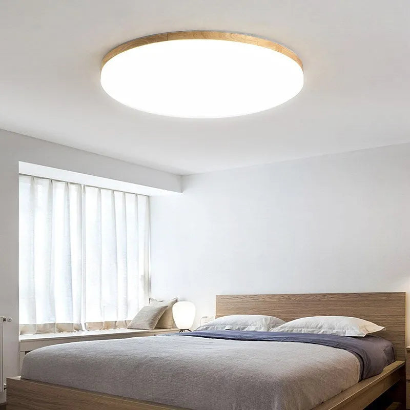 Japanese minimalist ceiling lamp with wood art body and acrylic shade in three available sizes.