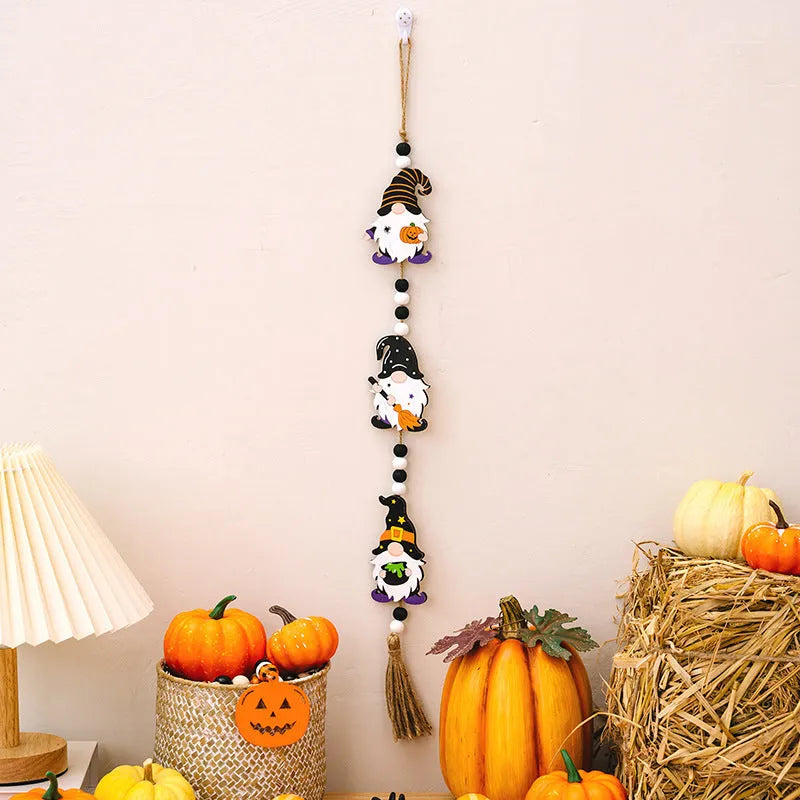 Resin Halloween pendant string with BOO ghost design hanging on a wall