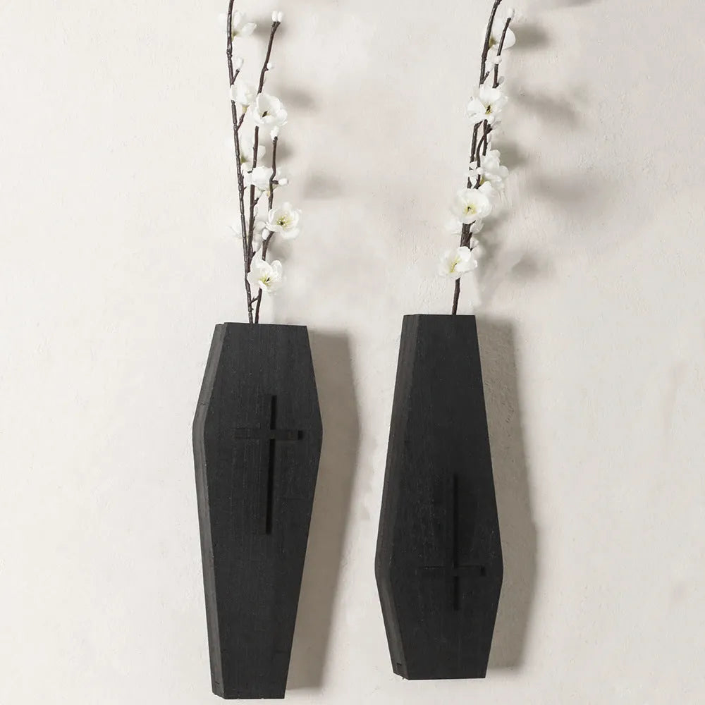 Black wooden cross-shaped wall shelf with dimensions 27cm by 9cm for displaying small decorative items.
