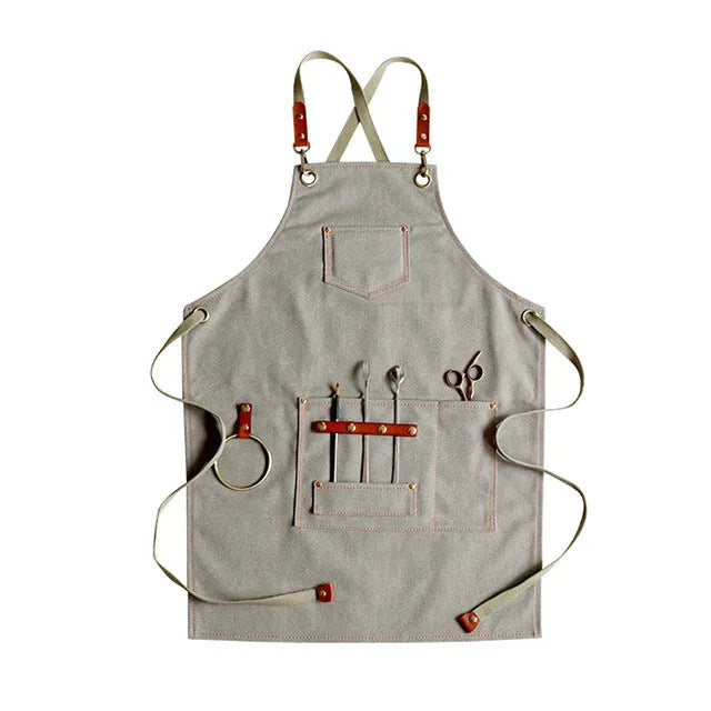 Canvas cross-strap apron in camel colour on hanger