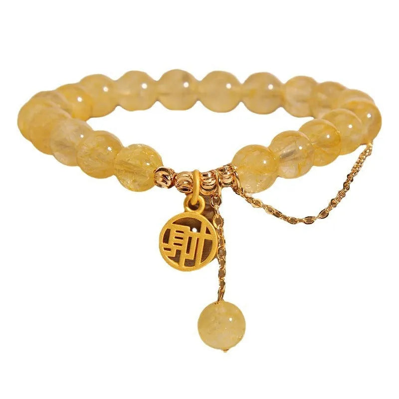 Women's natural citrine bracelet with gold electroplated Chinese character charm on an adjustable dark cord.