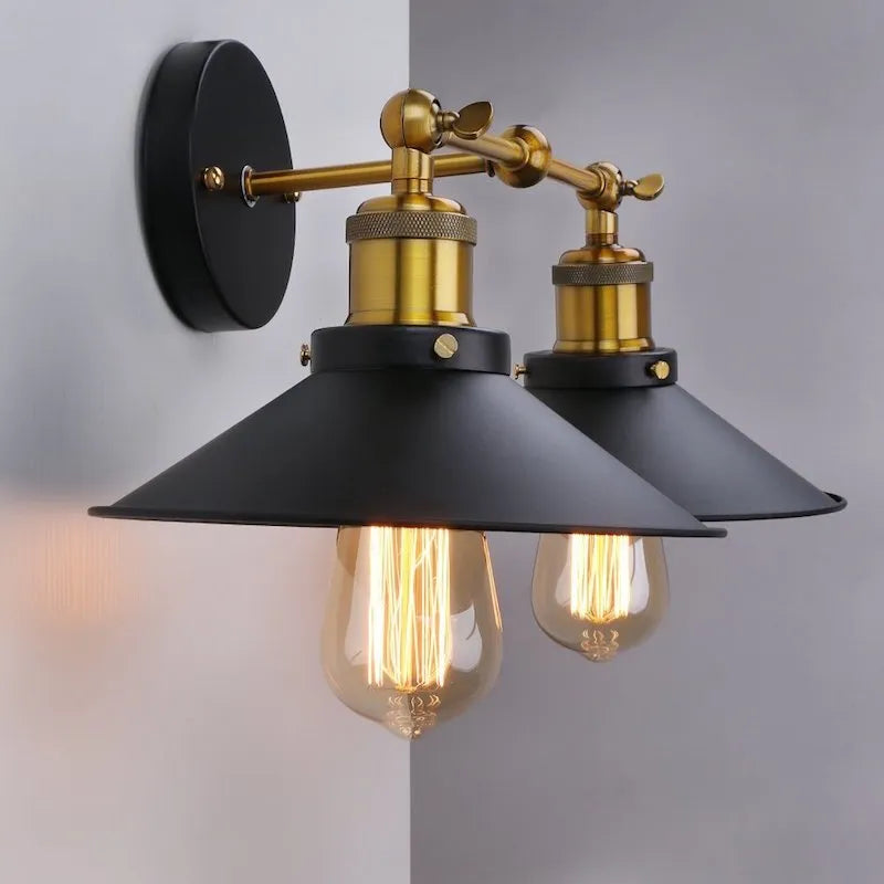 Black double head American retro industrial style iron wall lamp on a wall.