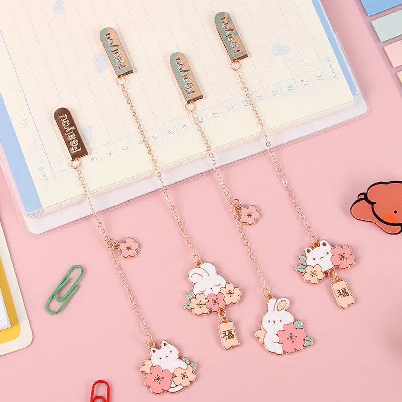 Metal book holder with pendant featuring cute cartoon cherry cat or rabbit sakura design