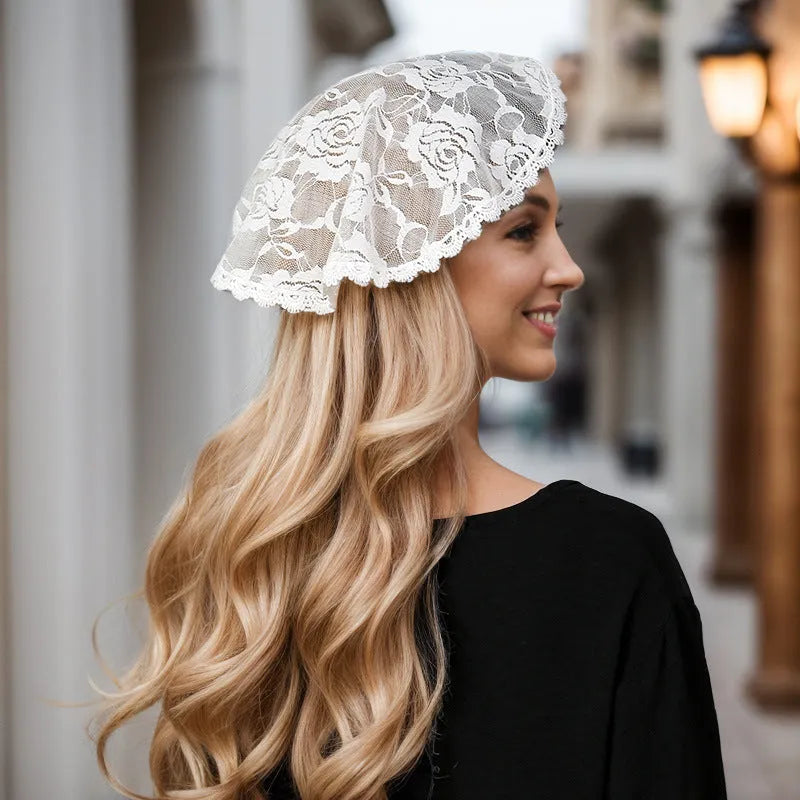 Round white bridal head cover with floral decoration measuring 30cm.