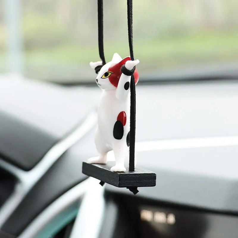 Resin cartoon cat pendant for car interior decoration with adjustable rope, shown in multiple colour options.