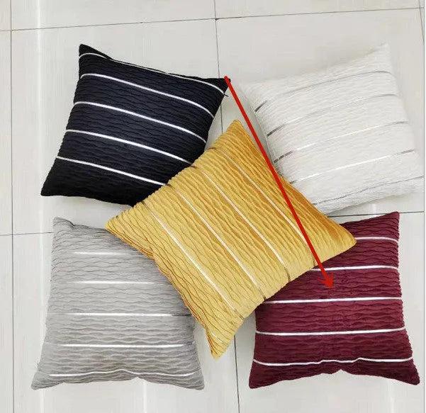 Square 45cm plush velvet pillow cover in wine red colour on a sofa.