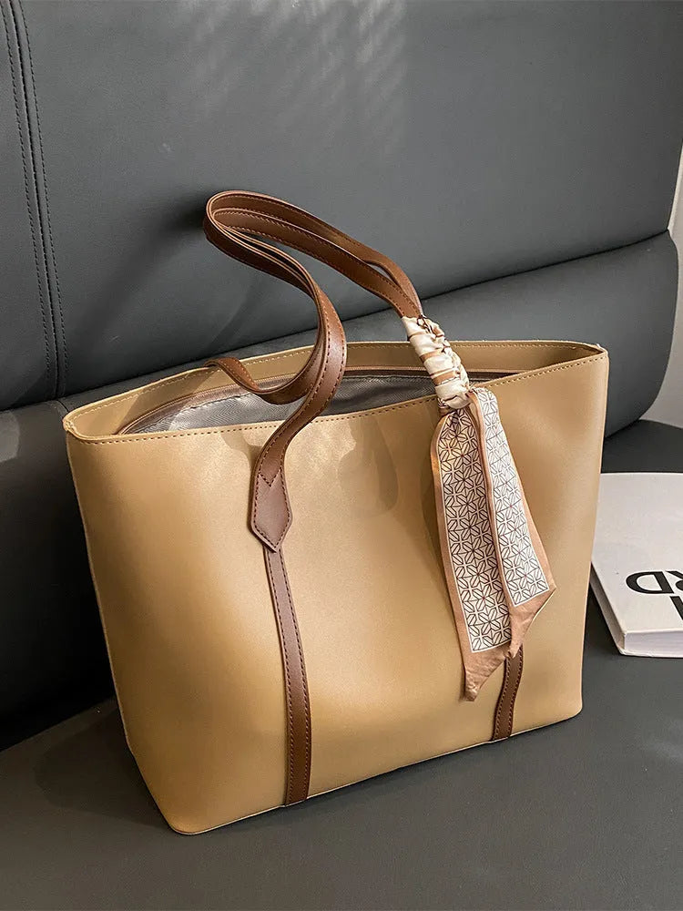 Women's soft bucket tote bag in multiple colours with crossbody strap and zippered internal compartment