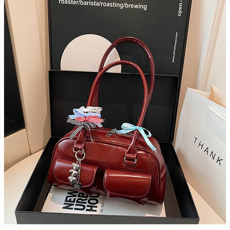 Retro style women's PU leather pillow-shaped flap handbag in black, shown with a double shoulder strap.