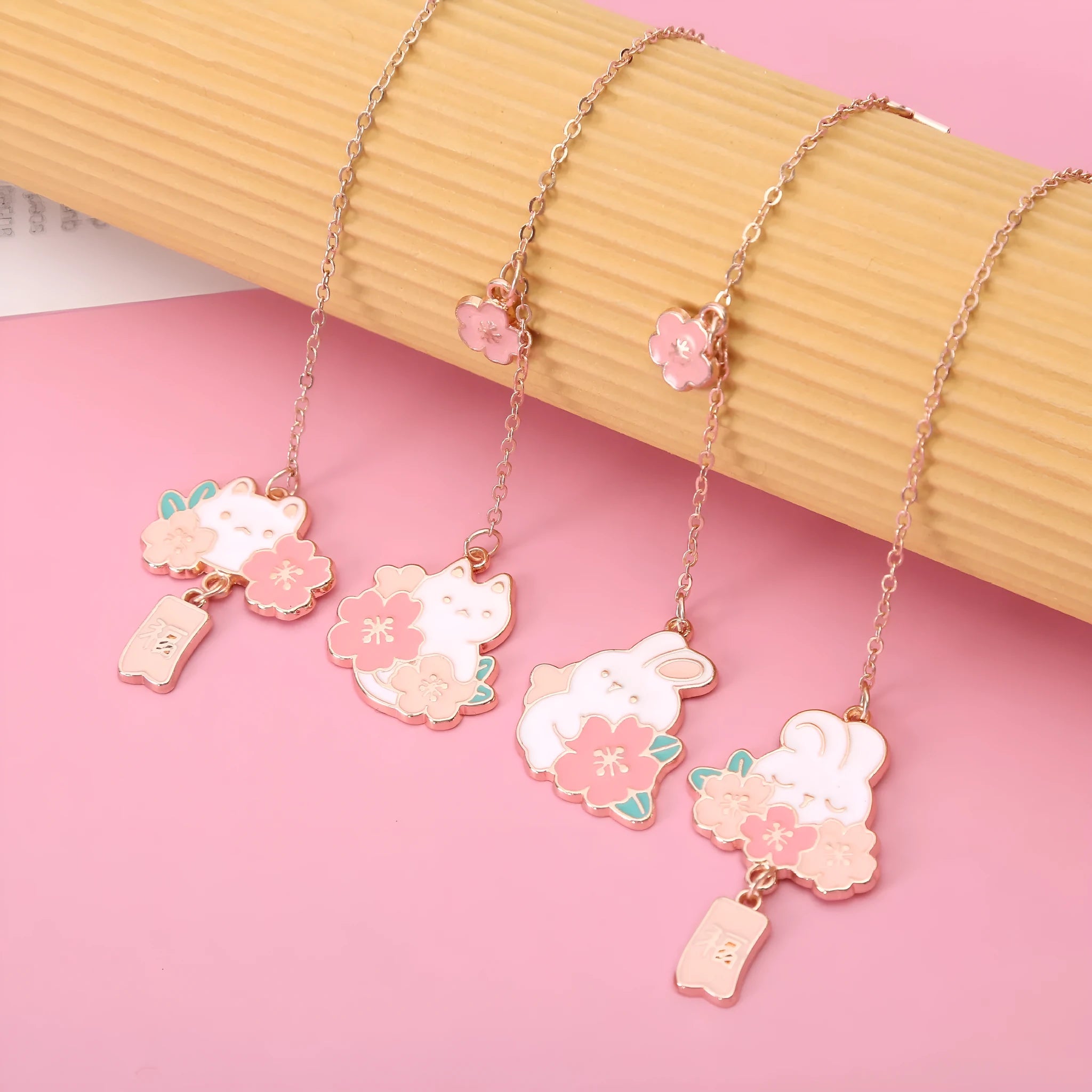Metal book holder with pendant featuring cute cartoon cherry cat or rabbit sakura design
