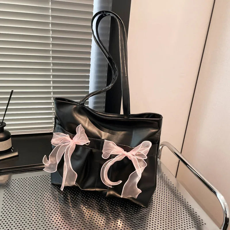 College style bow tote bag in black with double shoulder straps and decorative bow