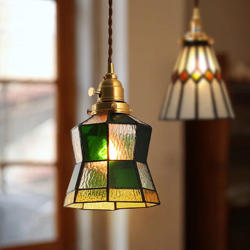Retro brass and glass chandelier with hand-blown shades hanging on a braided hemp rope light line.