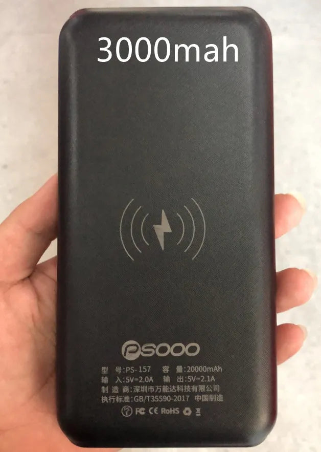Black portable power bank with wireless Qi charging pad, three USB ports, and LED flashlight for iPhone Samsung Xiaomi phones