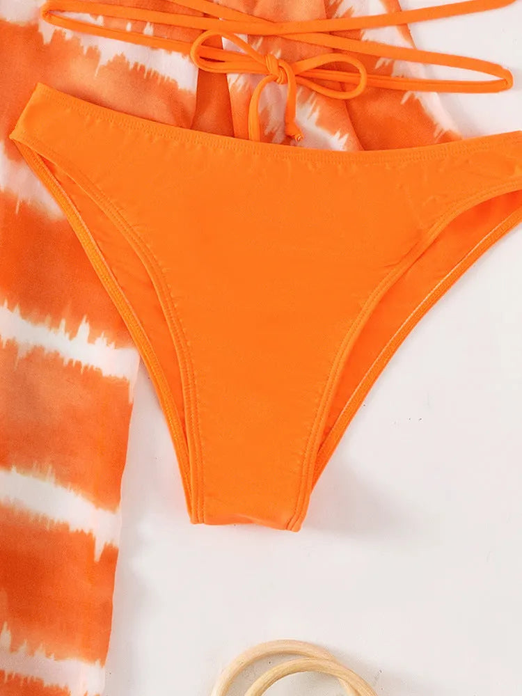 Women's orange three piece swimsuit with nylon colour blocking fabric, bra, panties and cardigan.