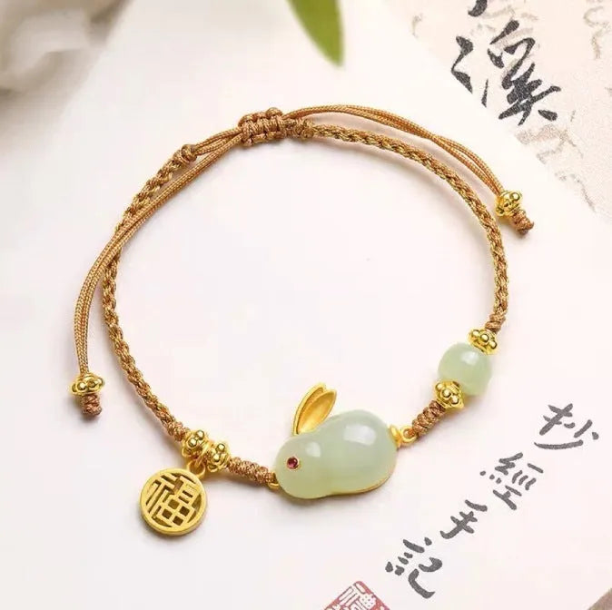 Hetian jade rabbit charm bracelet on yellow string with geometric shape